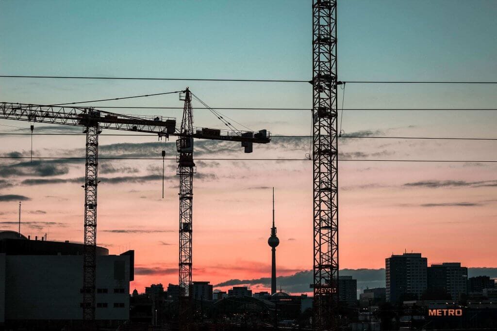 cranes against a sky at dusk