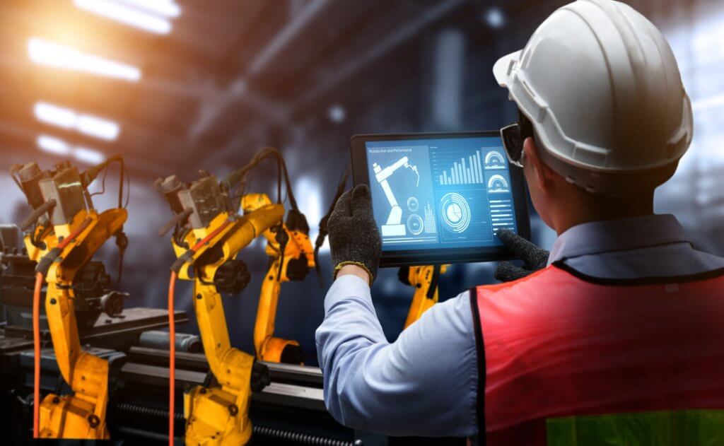 person using digital tablet to assess AI construction machinery
